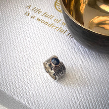 Load image into Gallery viewer, Solid sterling silver and gold ring set with deep blue, rose cut Sapphire. Size R1/2
