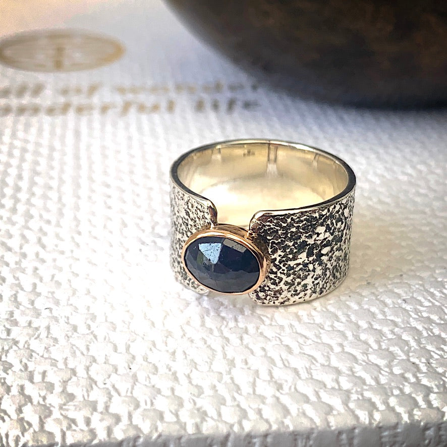 Solid sterling silver and gold ring set with deep blue, rose cut Sapphire. Size R1/2